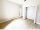 Clean, vacant bedroom features neutral walls, a closet, and tiled floors, ready for personalized updates at 1208 Sawgrass Pointe Dr, Orlando, FL 32824