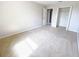 A bedroom with neutral carpeting, beige walls, and a walk-in closet at 1208 Sawgrass Pointe Dr, Orlando, FL 32824