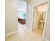 Bright hallway leading to a half-bath, offering access to essential amenities and enhancing convenience within the home at 1208 Sawgrass Pointe Dr, Orlando, FL 32824