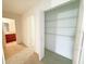 Hallway with a closet that has shelving, access to a bathroom, and light carpet at 1208 Sawgrass Pointe Dr, Orlando, FL 32824