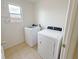 Bright laundry room with modern washer and dryer units and vinyl flooring at 1208 Sawgrass Pointe Dr, Orlando, FL 32824