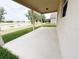 Covered patio with a beautiful view of the lake and lush green lawn at 1208 Sawgrass Pointe Dr, Orlando, FL 32824