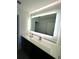Modern bathroom with a large illuminated mirror and sleek vanity at 14501 Grove Resort Ave # 3640, Winter Garden, FL 34787