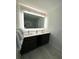 Double vanity bathroom with modern dark brown cabinets and large mirror at 14501 Grove Resort Ave # 3640, Winter Garden, FL 34787