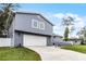 Gray house with white garage door and a large driveway at 626 Little Wekiva Rd, Altamonte Springs, FL 32714