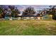 Large backyard with sprawling lawn and view of the home's exterior featuring ample natural light at 647 Ridgewood Dr, Windermere, FL 34786