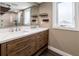 Modern bathroom featuring double vanity, quartz countertop, wood drawers, and large mirror reflecting the shower at 647 Ridgewood Dr, Windermere, FL 34786