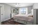 Bedroom featuring a queen bed, ceiling fan, built-in storage, and large window with water view at 647 Ridgewood Dr, Windermere, FL 34786