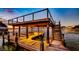 Modern covered boat dock with lighting and multiple levels at 647 Ridgewood Dr, Windermere, FL 34786
