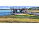 Waterfront dock featuring boat lifts, a spacious deck and a fence at 647 Ridgewood Dr, Windermere, FL 34786