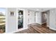 Bright entryway with a modern white front door, wood floors, and natural light from an adjacent window at 647 Ridgewood Dr, Windermere, FL 34786