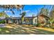 Green house with stone accents, spacious lawn, and mature trees at 647 Ridgewood Dr, Windermere, FL 34786