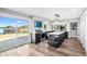 Modern kitchen boasts stainless appliances, center island, and sliding glass doors to patio with lake view at 647 Ridgewood Dr, Windermere, FL 34786