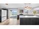 Kitchen with stainless appliances, island with cooktop, and sliding glass doors showing scenic lake view at 647 Ridgewood Dr, Windermere, FL 34786