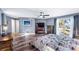 Main bedroom featuring wood floors, a ceiling fan, and a sliding glass door to a balcony with lake view at 647 Ridgewood Dr, Windermere, FL 34786
