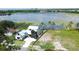 Picturesque aerial view of a modern lakeside home featuring lush greenery and expansive water views at 1340 Susannah Blvd, Orlando, FL 32803