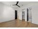 Expansive bedroom with hardwood floors, modern ceiling fan, and dark accent doors at 1340 Susannah Blvd, Orlando, FL 32803