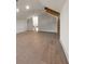 Spacious bonus room includes light hardwood floors, exposed beams, and access to a dark staircase at 1340 Susannah Blvd, Orlando, FL 32803