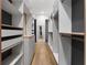 A walk-in closet with custom shelves and drawers, complemented by hardwood flooring at 1340 Susannah Blvd, Orlando, FL 32803