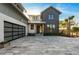 Modern two-story home boasting a contemporary design, a metal roof, a large driveway, and attractive landscaping at 1340 Susannah Blvd, Orlando, FL 32803
