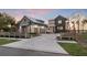 A modern home with a three-car garage, a metal roof, and a paved driveway at 1340 Susannah Blvd, Orlando, FL 32803