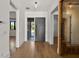 Inviting foyer with hardwood floors, a modern light fixture, and a glimpse into other rooms at 1340 Susannah Blvd, Orlando, FL 32803