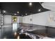Garage features a dark ceiling, an epoxy floor, bright lighting, and a window to the back yard at 1340 Susannah Blvd, Orlando, FL 32803