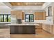 Stylish kitchen boasting stainless steel appliances, a large island, custom cabinets, and modern pendant lighting at 1340 Susannah Blvd, Orlando, FL 32803