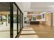 Open kitchen featuring custom cabinets, stainless appliances, a center island, hardwood floors, and outdoor access at 1340 Susannah Blvd, Orlando, FL 32803