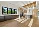 Spacious kitchen featuring custom cabinets, stainless appliances, a center island, hardwood floors, and a modern lighting fixture at 1340 Susannah Blvd, Orlando, FL 32803