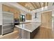 Bright kitchen featuring stainless steel appliances, wooden cabinets and a spacious island with marble countertops at 1340 Susannah Blvd, Orlando, FL 32803