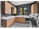 Well-lit laundry room with modern cabinets, sleek countertop, and patterned tile floor at 1340 Susannah Blvd, Orlando, FL 32803