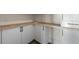 Clean laundry room with white cabinets, modern hardware, and wood countertop at 1340 Susannah Blvd, Orlando, FL 32803