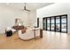 Well-lit modern living room with lake views, stylish furniture and wood flooring at 1340 Susannah Blvd, Orlando, FL 32803