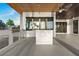 Outdoor kitchen with grill, stainless steel appliances, and expansive concrete patio overlooking the water at 1340 Susannah Blvd, Orlando, FL 32803