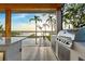 Outdoor kitchen and eating area with pool and lake views at 1340 Susannah Blvd, Orlando, FL 32803