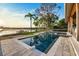 Relaxing pool and lakeside with beautiful dock, tropical landscaping, and plenty of room to enjoy at 1340 Susannah Blvd, Orlando, FL 32803