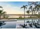 Relaxing backyard showcasing a luxurious pool with waterfront views and lush landscaping, perfect for enjoying serene sunsets at 1340 Susannah Blvd, Orlando, FL 32803
