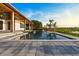Gorgeous backyard pool with lake views, a large patio, and beautiful landscaping at 1340 Susannah Blvd, Orlando, FL 32803