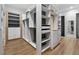 Spacious walk-in closet with custom built-in shelving and drawers at 1340 Susannah Blvd, Orlando, FL 32803
