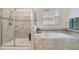 Modern bathroom with a large shower and a soaking tub at 1402 Olympic Club Blvd, Champions Gate, FL 33896