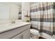Clean bathroom with gray vanity, striped shower curtain, and toilet at 1402 Olympic Club Blvd, Champions Gate, FL 33896