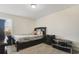Comfortable bedroom with a dark wood bed frame and nightstand at 1402 Olympic Club Blvd, Champions Gate, FL 33896