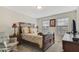Cozy bedroom with a wooden bed frame, nightstands, and window seating at 1402 Olympic Club Blvd, Champions Gate, FL 33896