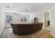 Spacious bonus room with large sectional sofa and plenty of natural light at 1402 Olympic Club Blvd, Champions Gate, FL 33896