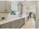 Kitchen boasts gray cabinets, quartz countertops, and a breakfast bar at 1402 Olympic Club Blvd, Champions Gate, FL 33896