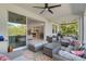 Relaxing screened lanai with wicker furniture and view of backyard at 1402 Olympic Club Blvd, Champions Gate, FL 33896