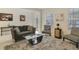 Living room featuring a gray couch, coffee table, and accent chairs at 1402 Olympic Club Blvd, Champions Gate, FL 33896