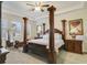 Elegant Primary bedroom with a four-poster bed and ample space at 1402 Olympic Club Blvd, Champions Gate, FL 33896
