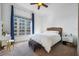 Bright bedroom featuring a large window with city views and simple, modern furniture at 155 S Court Ave # 1602, Orlando, FL 32801
